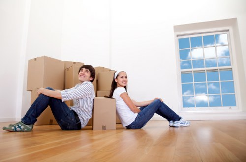 Movers using protective equipment while handling boxes during a Harringay move