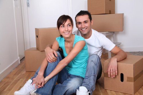 Professional movers loading household items into a van near Green Lanes