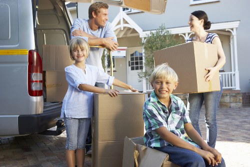 Professional movers carrying items from a flat in Harringay