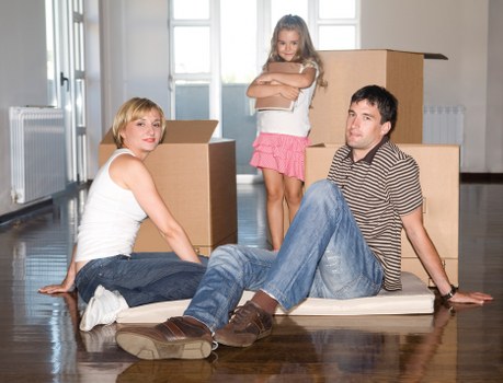 Movers using correct manual handling techniques for a heavy item